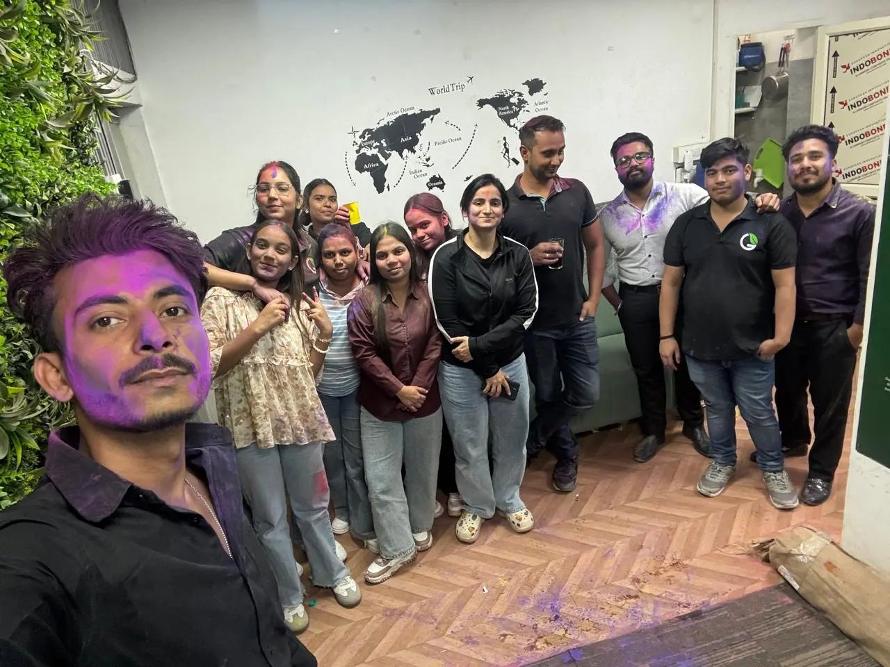 G Fresh Mart team members celebrating Holi with colours at the office